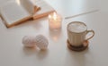 coffee cup, flower, candle and a book on a white table background top view Royalty Free Stock Photo