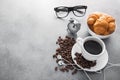 coffee cup with croissant and alarm clock, black glasses Royalty Free Stock Photo