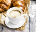 Coffee cup with croissant.Breakfast meal with fresh coffee and f