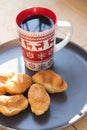 Coffee in a cup and croissants on a plate. Food and drinks. Plate on a wooden background