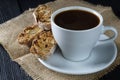 Coffee cup on dark wood background, with cantucci cookies Royalty Free Stock Photo