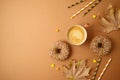 Coffee cup, donuts and autumn leaves. Fall season concept background Royalty Free Stock Photo