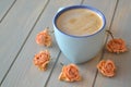 Coffee cup and dry rose flowers in cremy color on blue vintage table, provence style