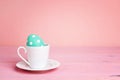 Coffee cup with Easter egg on a pink table. Royalty Free Stock Photo