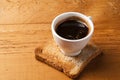 Coffee cup of espresso with toast on a wooden table Royalty Free Stock Photo