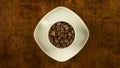 Coffee cup filled with beans stop motion animation turning clockwise topview