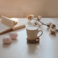 coffee cup, flower, candle and a book on a white table background top view. minimal home interior decor Royalty Free Stock Photo