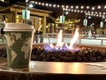 Coffee cup in front of  fire rink at ski resort Royalty Free Stock Photo