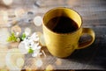 Coffee cup on garden table with dold bokeh. Royalty Free Stock Photo