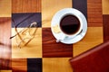 Coffee cup with glasses and leather folder on table retro Royalty Free Stock Photo