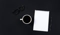 Coffee cup ,glasses and white notepad with pen on black background. top view Royalty Free Stock Photo