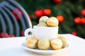 Horizontal picture of coffee cup with golden Christmas balls inside and around. Coffee pair on white table angle, grey Royalty Free Stock Photo