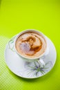 Coffee cup on green background