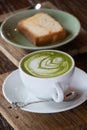 Coffee cup with Green Matcha latte art foam on wood table in coffee shop with copy space.Coffee is one of the most popular Royalty Free Stock Photo