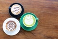 Coffee cup with Green Matcha latte art foam on wood table in coffee shop with copy space.Coffee is one of the most popular Royalty Free Stock Photo