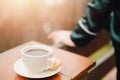 Coffee cup in hand beautiful young woman in pajamas