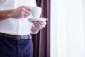 Coffee cup in hands of a nice successful businessman