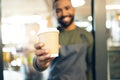 Coffee cup, hands and waiter in cafe offer drink, warm beverage and catering for hospitality services in startup Royalty Free Stock Photo