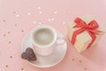 Coffee cup, heart shaped chocolate cookie, gift box and golden confetti on pink background. Valentines day concept. Top Royalty Free Stock Photo