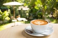 Coffee cup with hot coffee on old wood table in blur green natur Royalty Free Stock Photo