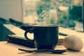 Coffee cup with hot coffee on wood background in morning
