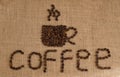 Coffee cup image made up of coffee beans on burlap background Royalty Free Stock Photo