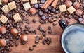 Coffee cup and ingredients on wood background