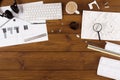 Coffee Cup, Keyboard, and Tools on a Wooden Table Showing Design Plans for a Building Project Royalty Free Stock Photo