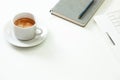 Coffee cup , laptop and grey notpad on white table. Selective focus