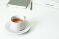 Coffee cup , laptop and grey notpad on white table. Selective focus