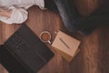 Coffee cup, laptop, notebooks, pencil, and women lying on the wooden floor