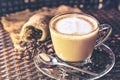 Coffee cup latte art and cappuccino with heart-shaped made from milk on the wood table with roasting coffee beans.Beverage and bre Royalty Free Stock Photo