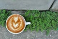 Coffee cup with latte art on the concrete floor Royalty Free Stock Photo