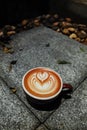 Coffee cup with latte art on the floor Royalty Free Stock Photo