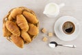 Coffee cup, lumpy sugar, jug milk, croissants in wicker basket Royalty Free Stock Photo