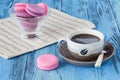 Coffee cup with macaroons and musical notes in background