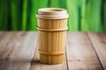 a coffee cup made from bamboo on a wooden table Royalty Free Stock Photo