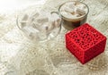 Coffee cup with marshmallows glass bowl with marshmallows red ring box on beige lace tablecloth vintage romance surprise