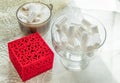 Coffee cup with marshmallows glass bowl with marshmallows red ring box on beige lace tablecloth vintage romance surprise