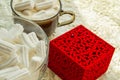 Coffee Cup with marshmallows ring in a box on the table with lace tablecloth, surprise concept for woman Royalty Free Stock Photo