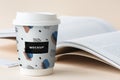 Takeaway Coffee Cup Mockup On A Table With An Open Book