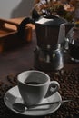 Coffee cup, moka pot coffee maker and roasted coffee bean on wooden table. Royalty Free Stock Photo