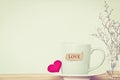 Coffee cup mug with red heart shapeand love word tag on wooden t Royalty Free Stock Photo