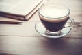 Coffee cup with newpaper on wood table in morning