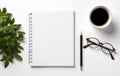 a coffee cup, notebook, and glasses next to a blank page Royalty Free Stock Photo