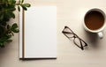 a coffee cup, notebook, and glasses next to a blank page Royalty Free Stock Photo