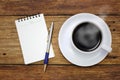 Coffee cup notebook and pen on the wooden table Royalty Free Stock Photo