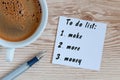 Coffee cup and notebook with To do list Make More Money on rustic desk from above, invest planning design concept Royalty Free Stock Photo