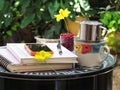 Coffee cup, notebooks, pencil and flowers on green steel table do it yourself. corner relax concept.