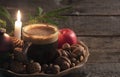 Coffee cup and nuts at candlelight for Xmas Royalty Free Stock Photo